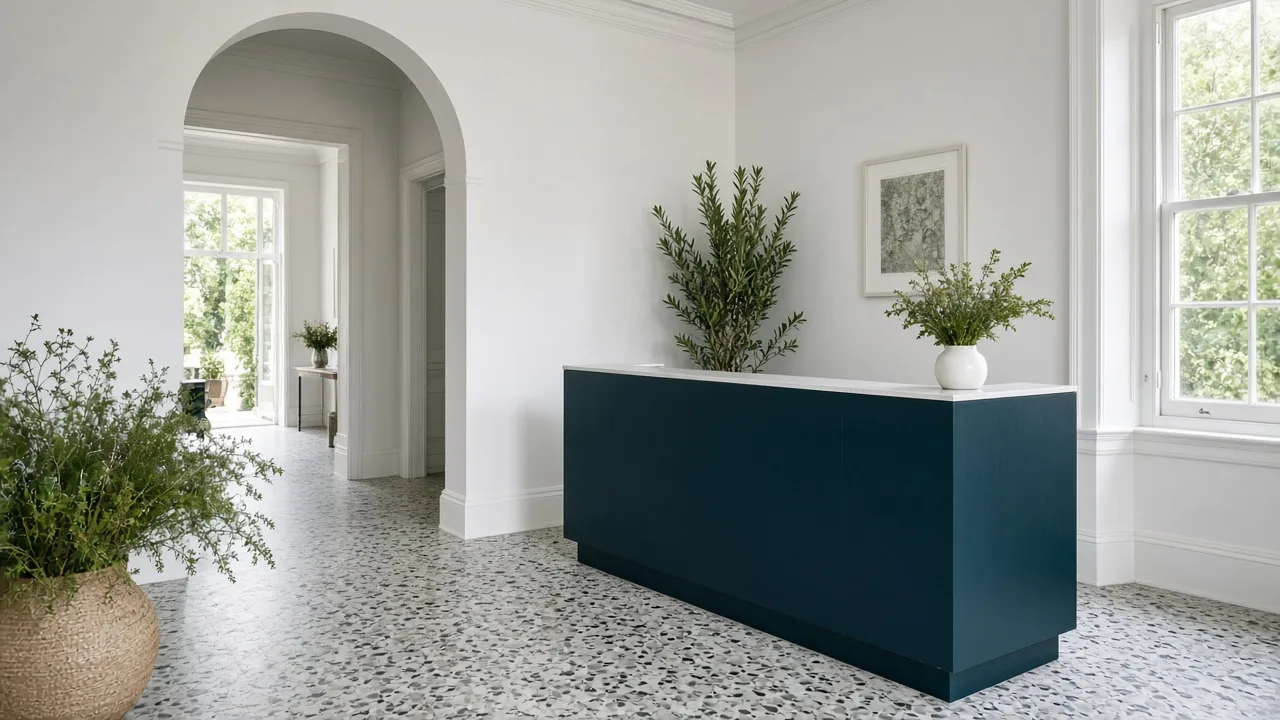 Reception at Blinkwater Dental with a navy desk and terrazzo floor inside the Victorian house